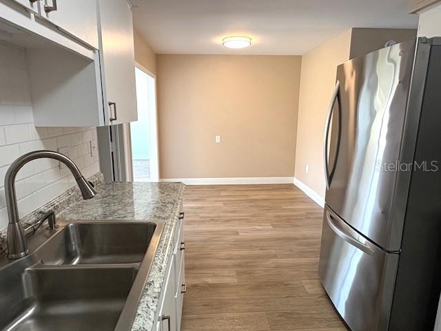 1005 Rickenbacker Drive Sun City Center, FL 33573 - Photo 12 of 57 a close view of a sink and a refrigerator in a kitchen