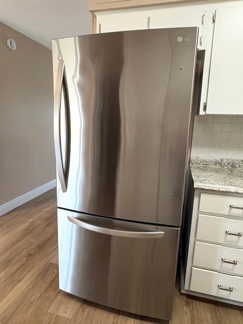 1005 Rickenbacker Drive Sun City Center, FL 33573 - Photo 13 of 57 a view of a refrigerator in kitchen