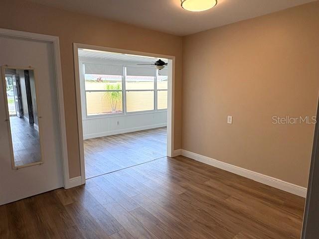 1005 Rickenbacker Drive Sun City Center, FL 33573 - Photo 14 of 57 an empty room with wooden floor and windows