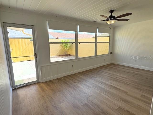 1005 Rickenbacker Drive Sun City Center, FL 33573 - Photo 15 of 57 an empty room with wooden floor and windows