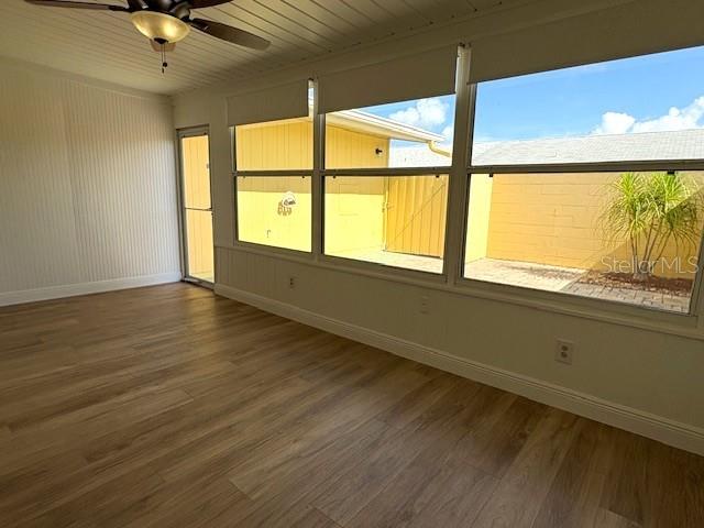 1005 Rickenbacker Drive Sun City Center, FL 33573 - Photo 17 of 57 a view of an empty room with wooden floor and a window