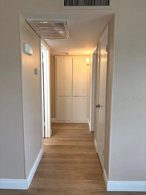 1005 Rickenbacker Drive Sun City Center, FL 33573 - Photo 21 of 57 a view of a hallway with wooden floor