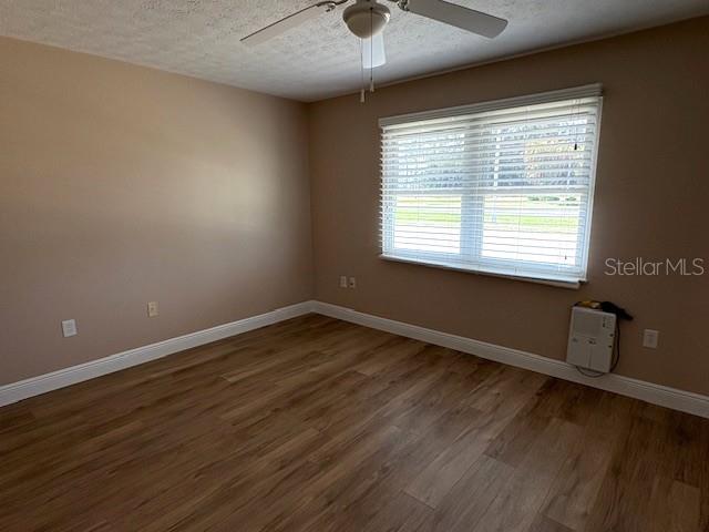 1005 Rickenbacker Drive Sun City Center, FL 33573 - Photo 28 of 57 a view of an empty room with wooden floor and a window