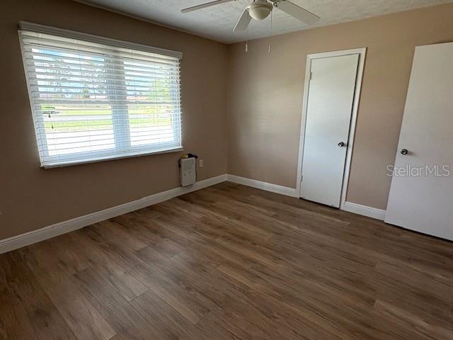 1005 Rickenbacker Drive Sun City Center, FL 33573 - Photo 29 of 57 a view of an empty room with wooden floor and a window