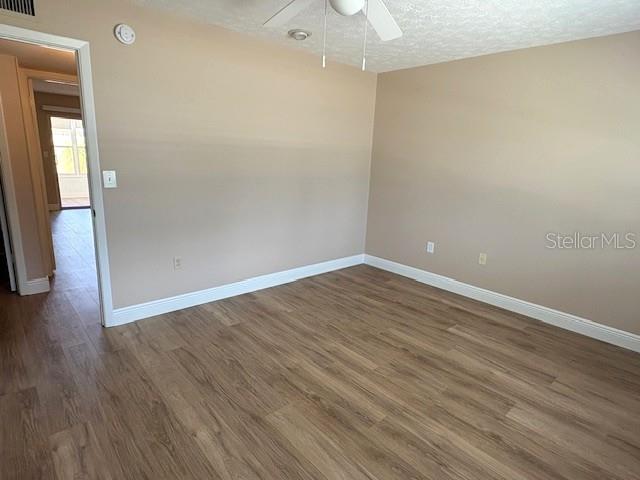 1005 Rickenbacker Drive Sun City Center, FL 33573 - Photo 30 of 57 a view of an empty room with wooden floor and a window