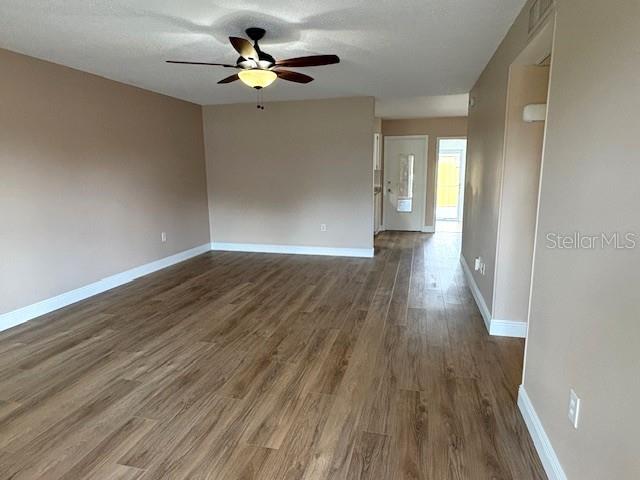 1005 Rickenbacker Drive Sun City Center, FL 33573 - Photo 3 of 57 a view of empty room with wooden floor and fan