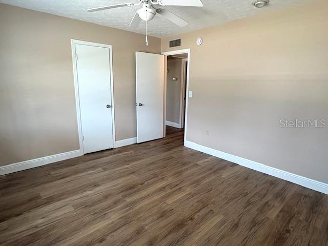 1005 Rickenbacker Drive Sun City Center, FL 33573 - Photo 31 of 57 an empty room with wooden floor and a ceiling fan