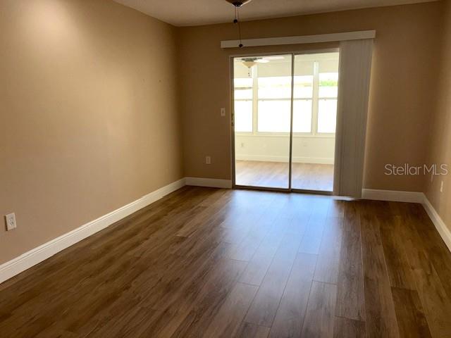 1005 Rickenbacker Drive Sun City Center, FL 33573 - Photo 34 of 57 a view of an empty room with wooden floor and a window