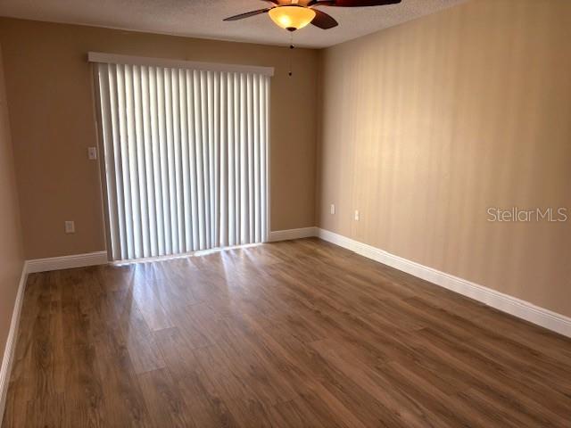 1005 Rickenbacker Drive Sun City Center, FL 33573 - Photo 35 of 57 an empty room with wooden floor and windows