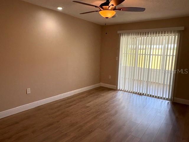 1005 Rickenbacker Drive Sun City Center, FL 33573 - Photo 36 of 57 an empty room with wooden floor and windows