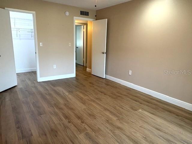 1005 Rickenbacker Drive Sun City Center, FL 33573 - Photo 38 of 57 an empty room with wooden floor and windows