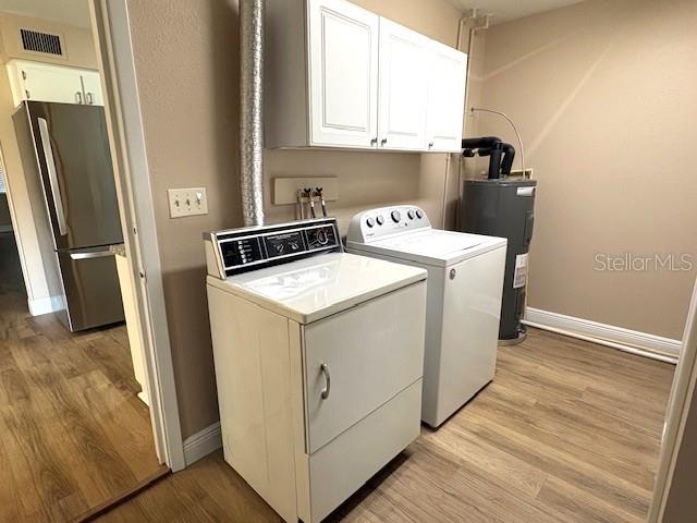 1005 Rickenbacker Drive Sun City Center, FL 33573 - Photo 44 of 57 a utility room with wooden floor washer and dryer
