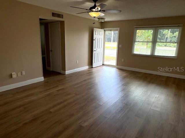 1005 Rickenbacker Drive Sun City Center, FL 33573 - Photo 6 of 57 a view of an empty room with wooden floor and a window