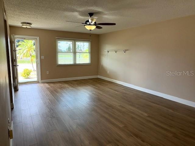 1005 Rickenbacker Drive Sun City Center, FL 33573 - Photo 7 of 57 an empty room with wooden floor and windows