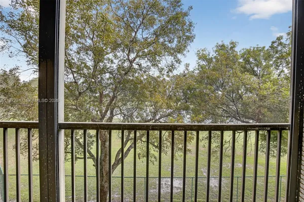 a view of a balcony with trees