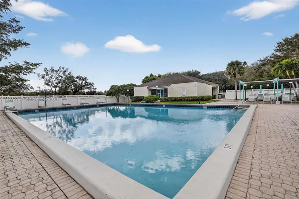 a view of a swimming pool with an outdoor seating