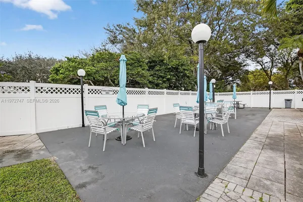 a view of a patio with a table and chairs