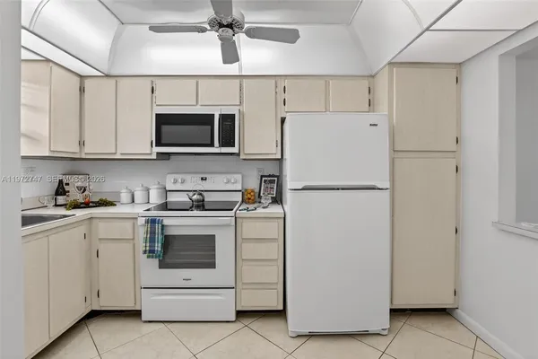 a kitchen with cabinets stainless steel appliances and a counter space