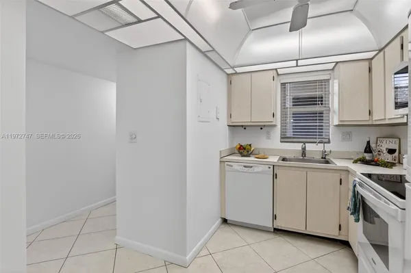 a kitchen with a sink window and cabinets