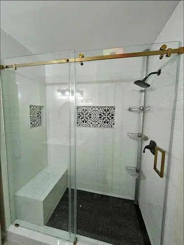 a bathroom with a granite countertop sink a toilet and shower