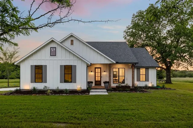 a front view of house with yard and green space