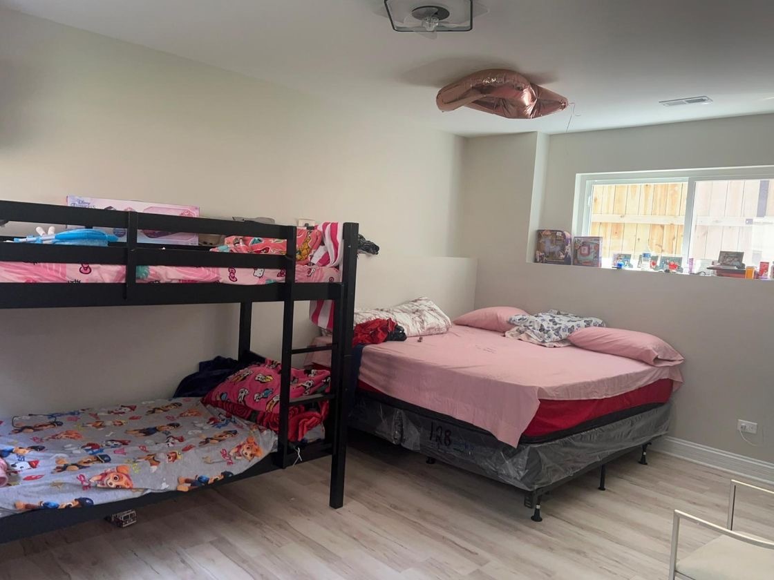 1051 North Springfield Avenue Chicago, IL 60651 - Photo 11 of 50 a bedroom with a bed and a dresser