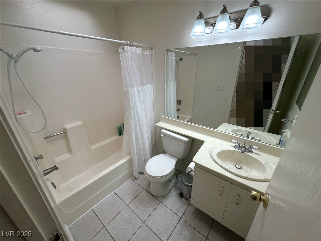 3936 Rive Gauche Street Las Vegas, NV 89115 - Photo 8 of 30 Bathroom with shower / tub combo with curtain, tile patterned floors, vanity, and toilet