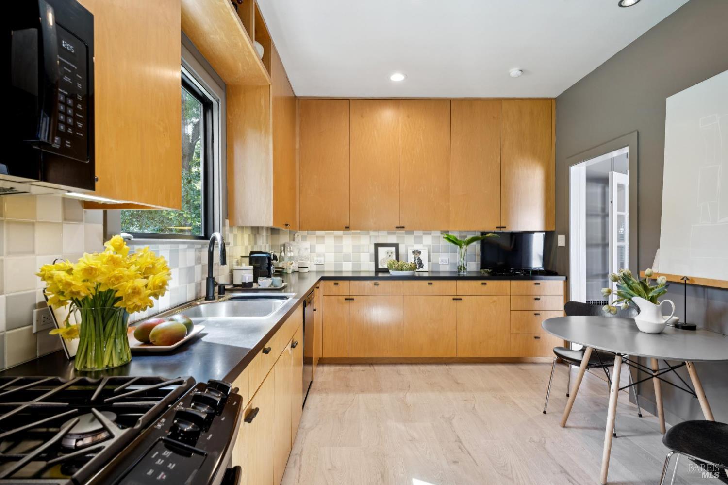 22 Clyde Avenue San Rafael, CA 94901 - Photo 18 of 66 a kitchen with stainless steel appliances kitchen island granite countertop a table chairs and a stove