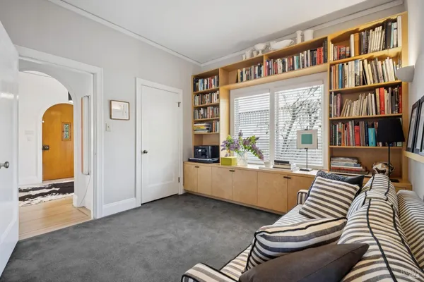 a spacious bedroom with a bed a couch and dresser