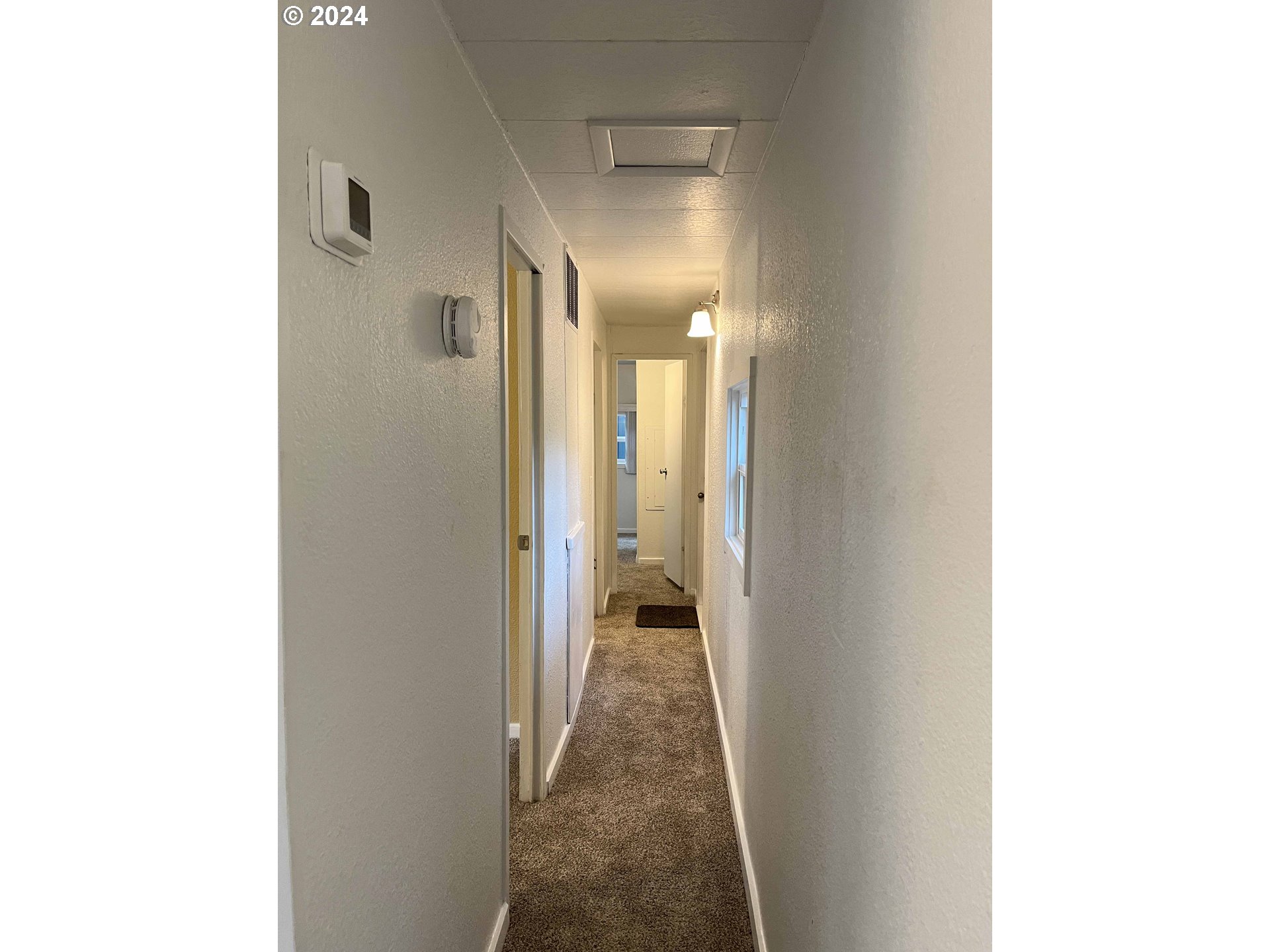 85313 Glenada Road Florence, OR 97439 - Photo 18 of 48 a view of a hallway with wooden floor
