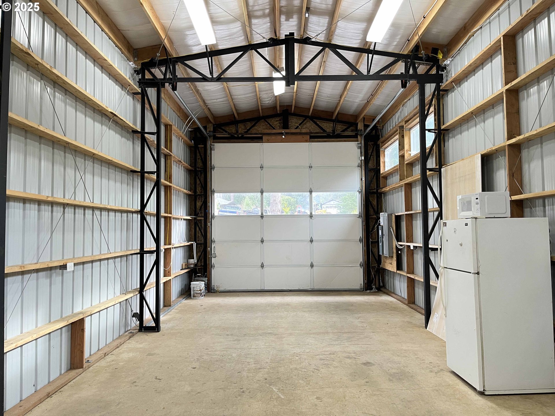 85313 Glenada Road Florence, OR 97439 - Photo 30 of 48 a view of a garage with wooden floor