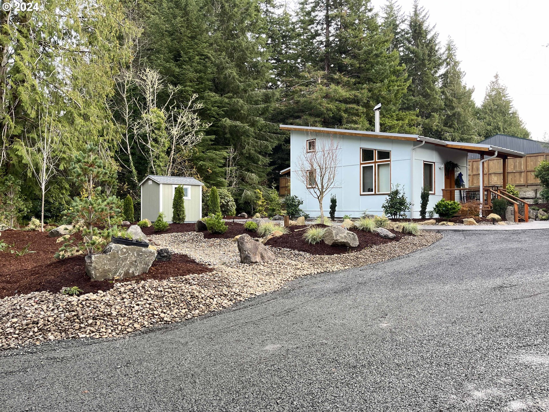 85313 Glenada Road Florence, OR 97439 - Photo 35 of 48 a view of a house with backyard and trees