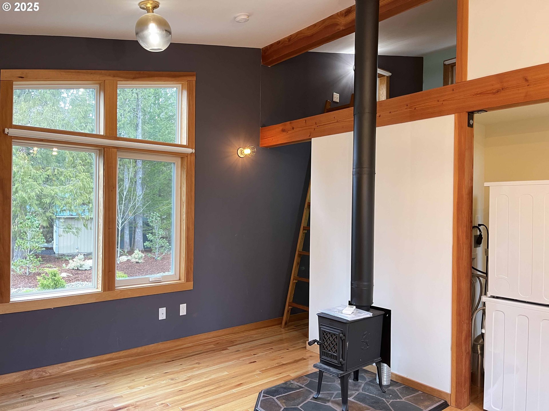 85313 Glenada Road Florence, OR 97439 - Photo 38 of 48 a view of an empty room with a window and wooden floor