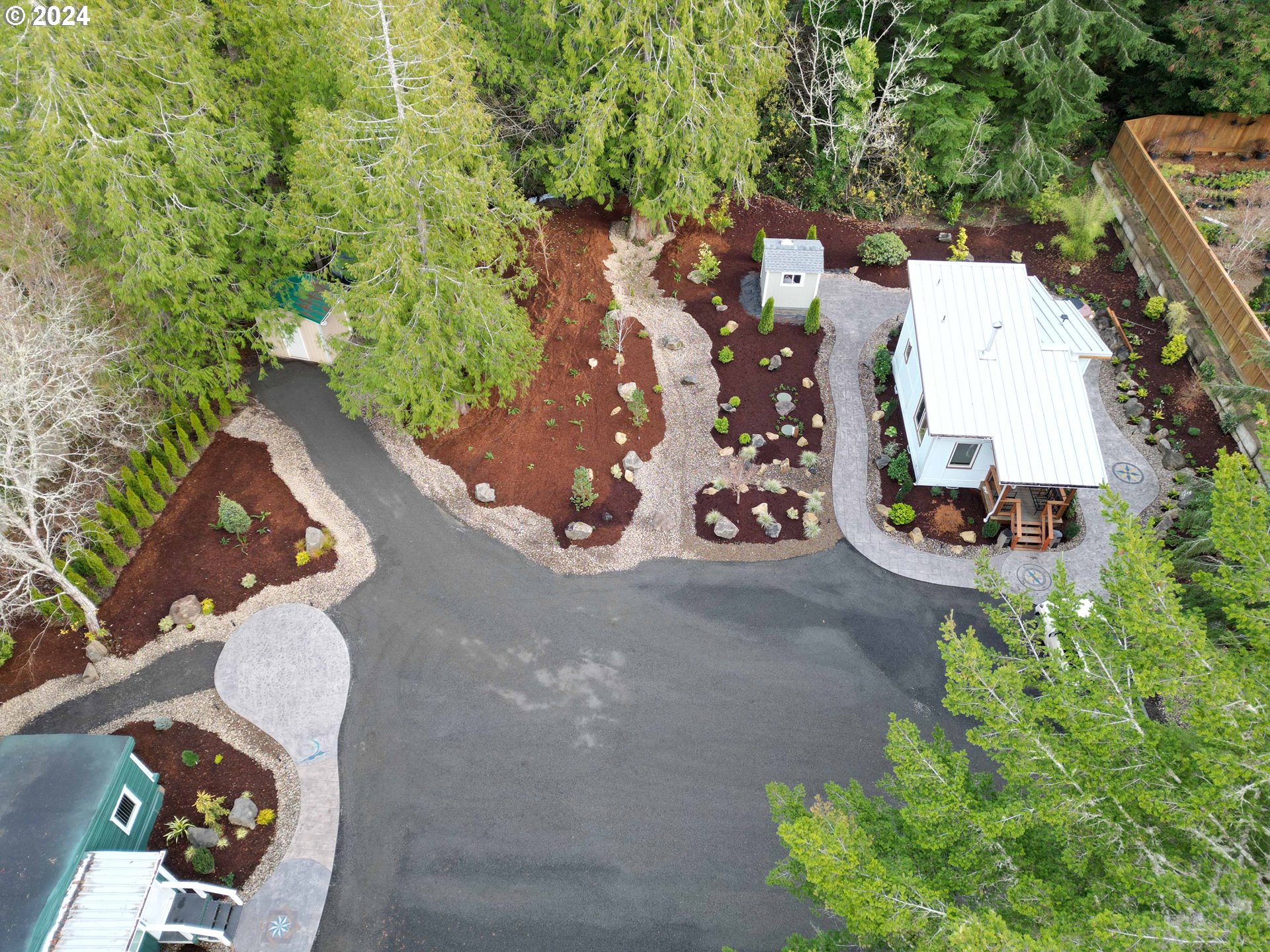 85313 Glenada Road Florence, OR 97439 - Photo 4 of 48 an aerial view of a house with a yard and a garage