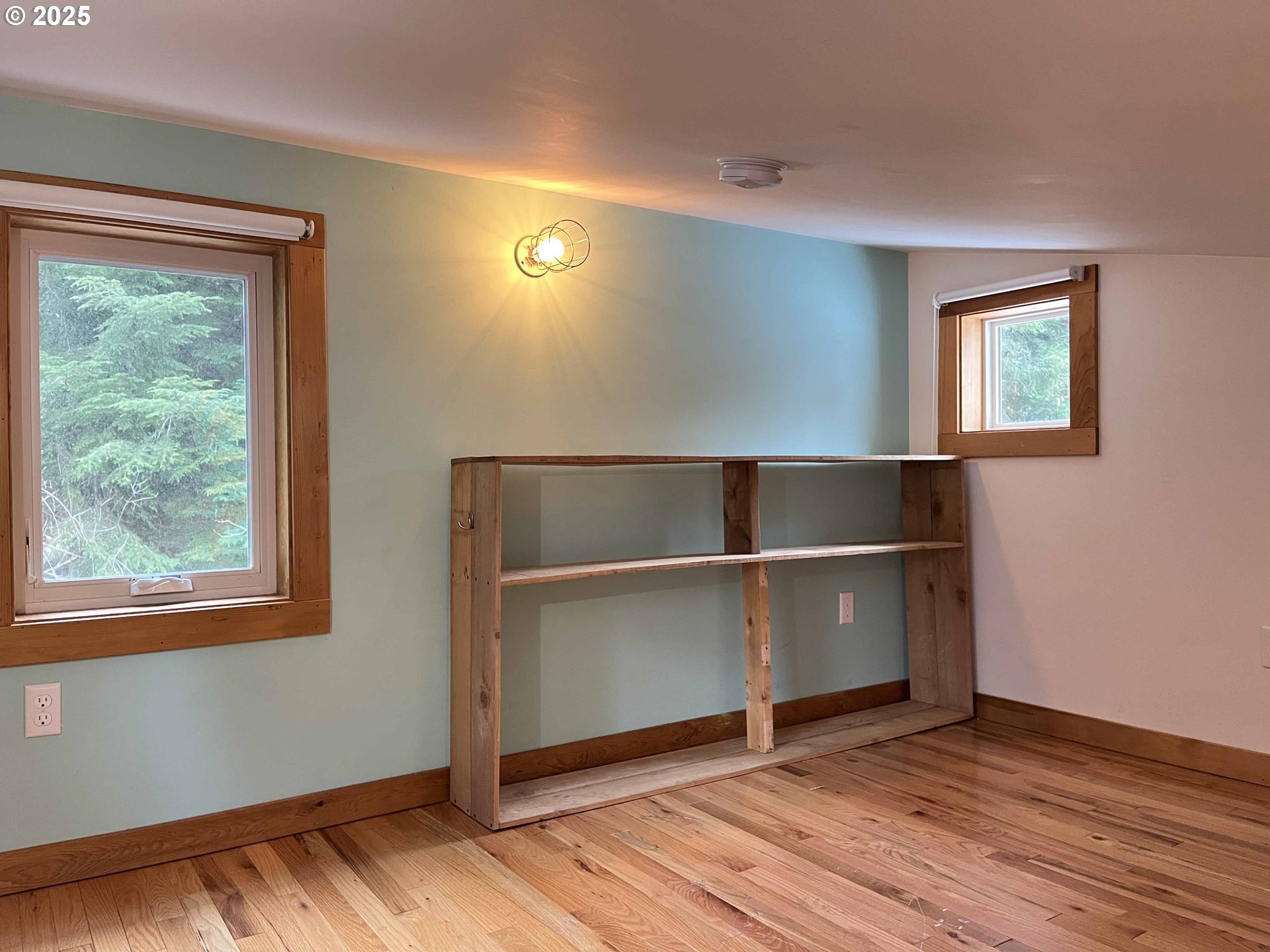85313 Glenada Road Florence, OR 97439 - Photo 41 of 48 a view of an empty room with wooden floor and a window