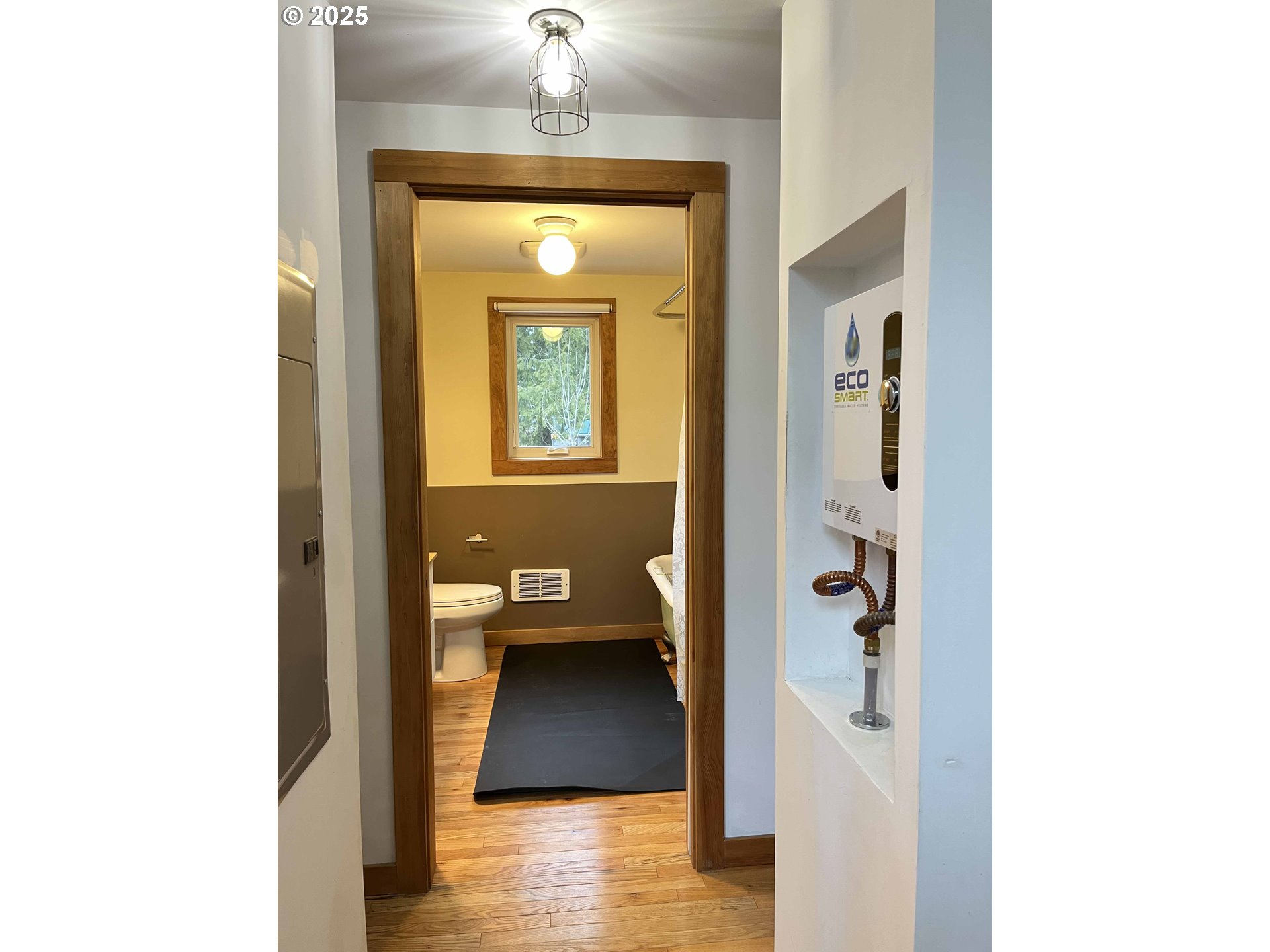 85313 Glenada Road Florence, OR 97439 - Photo 45 of 48 a view of a hallway with wooden floor and a living room