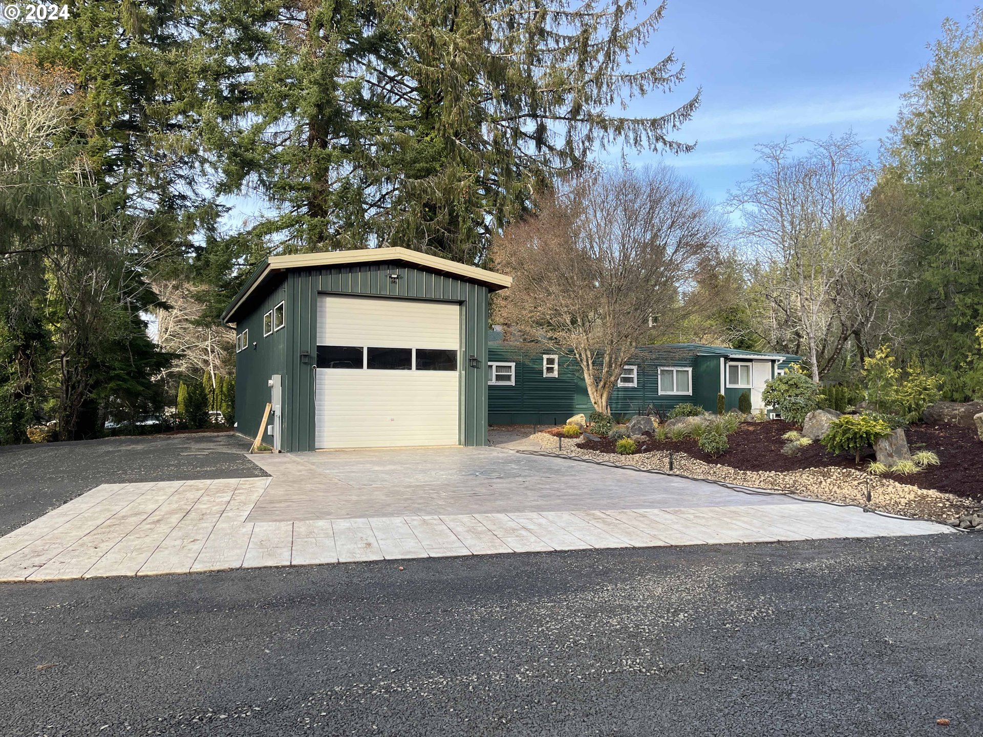 85313 Glenada Road Florence, OR 97439 - Photo 8 of 48 a front view of a house with a yard and garage