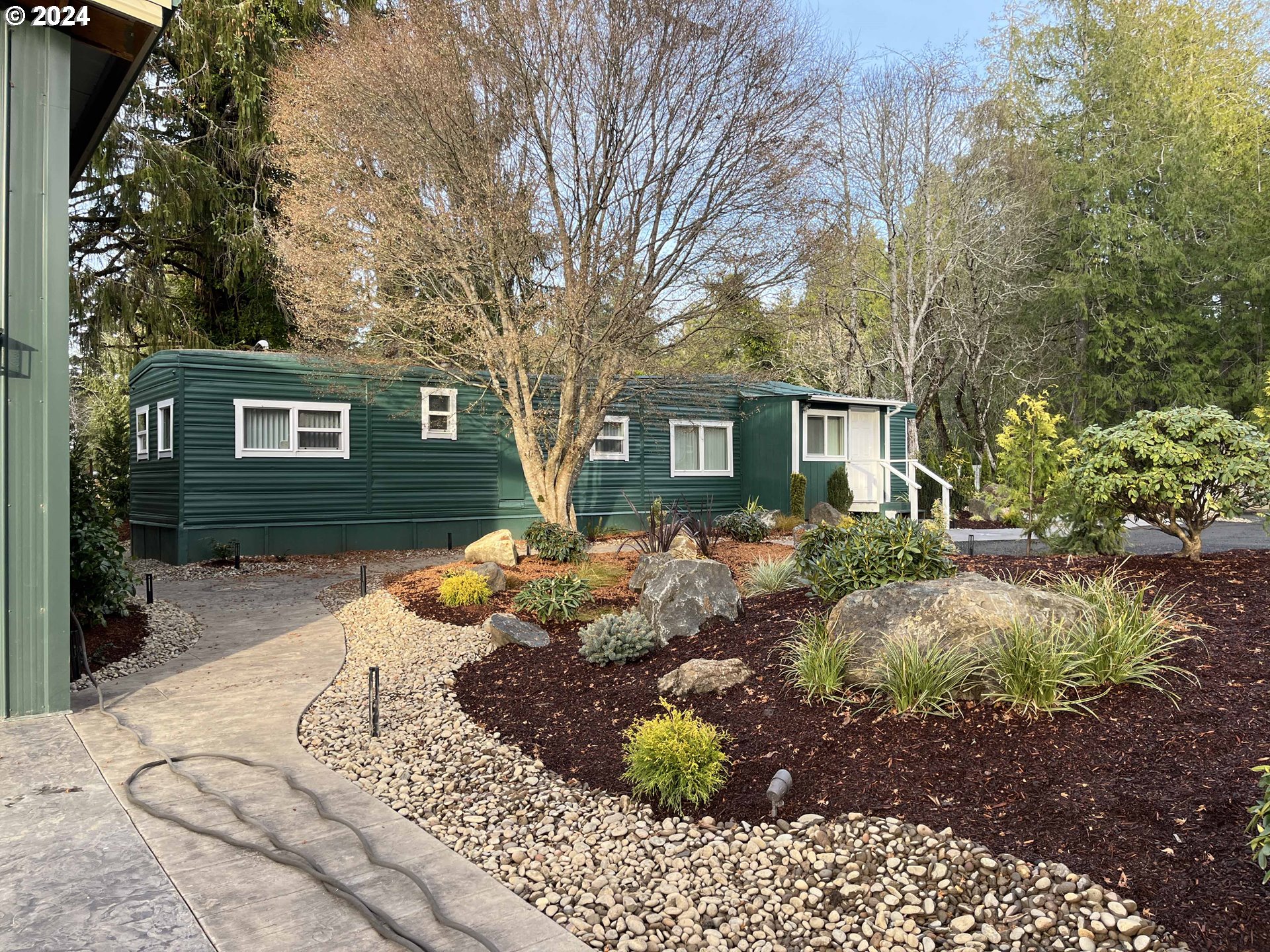 85313 Glenada Road Florence, OR 97439 - Photo 10 of 48 a front view of a house with a yard and outdoor seating