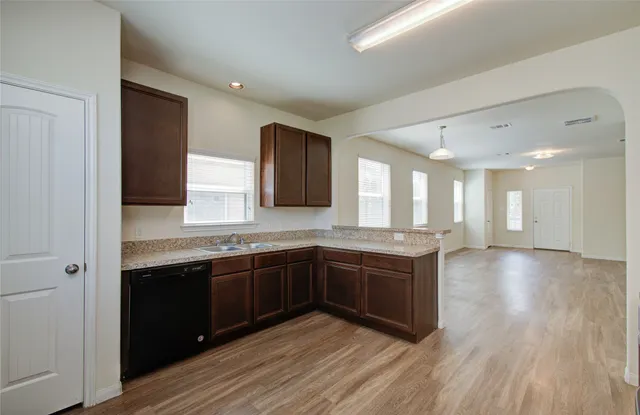 a spacious bathroom with a granite countertop sink and a mirror