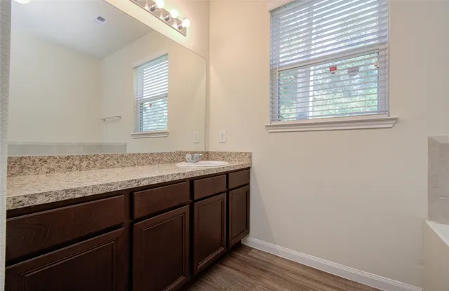 a white bath tub sitting next to a shower