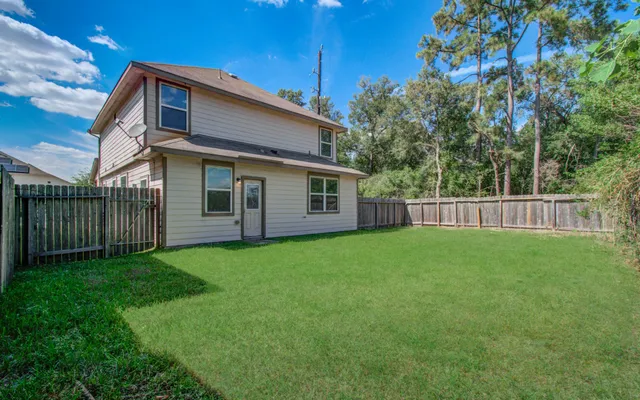 a view of a yard with a large tree