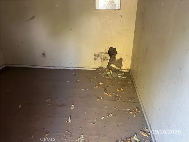a view of a house with a wooden fence