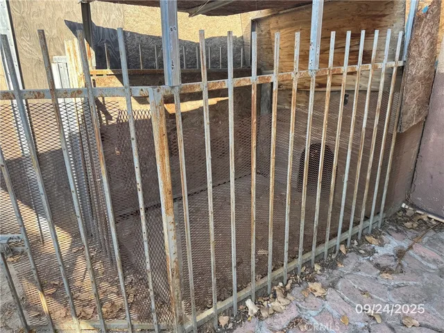 an empty room with wooden floor and a ceiling fan