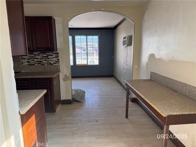 an empty room with a window and a ceiling fan