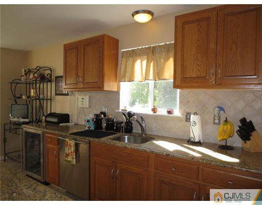124 Disbrow Road Old Bridge, NJ 07747 - Photo 4 of 10 a kitchen with a sink and cabinets