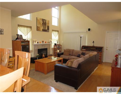 124 Disbrow Road Old Bridge, NJ 07747 - Photo 8 of 10 a living room with furniture and a fireplace
