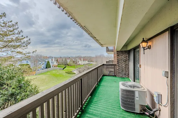 a view of a porch with furniture and a garden