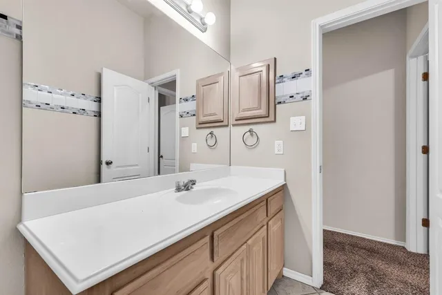 a bathroom with a sink vanity and a mirror