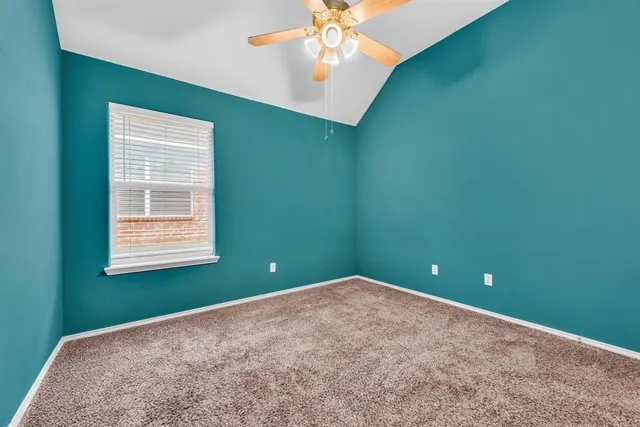 a view of a livingroom with a ceiling fan and a window