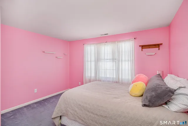 a bed room with a bed and a chair